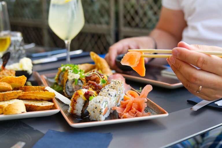 eating sushi with chopsticks at sushi restaurant